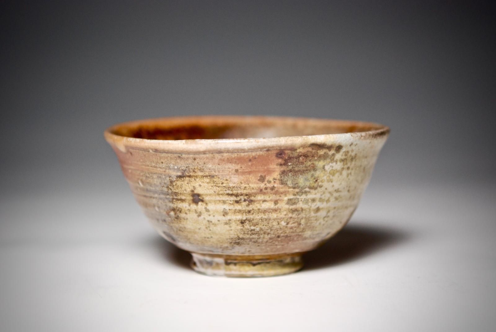 Kick wheel thrown chawan using local Devon clays, and then wood fired for four days in a ground hog type tunnel kiln.  Shino Glazed Interior, unglazed exterior. by Nic Collins