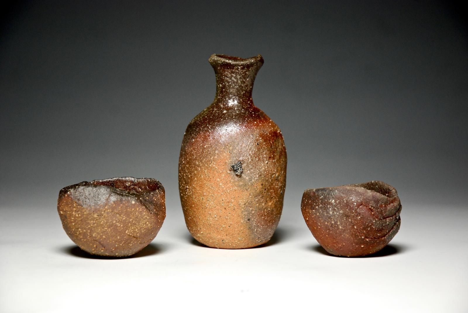 Sake set, 1 Tokkuri with 2 GuinomiVirginia and Minnesota kaolinitic claysCrushed rhyolite and graniteAnagama fired for 4 days to cone 8 by Mitch Iburg