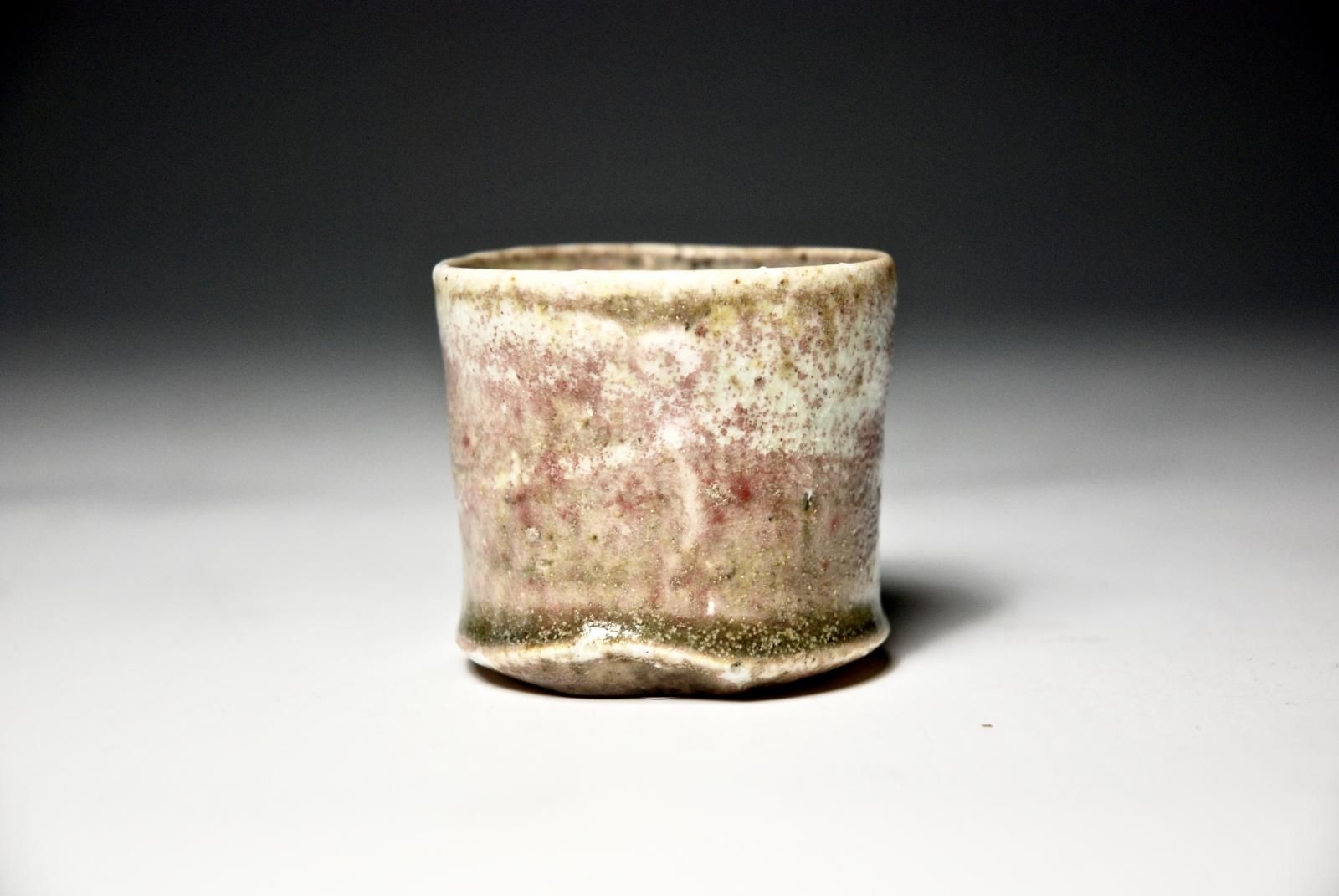 Petit Cup, Individual, slow thrown and hand trimmed Foot.  Porcelain Body with Locally sourced indeigneous Rock Grits.  Celadon Glaze. by Sim Taylor